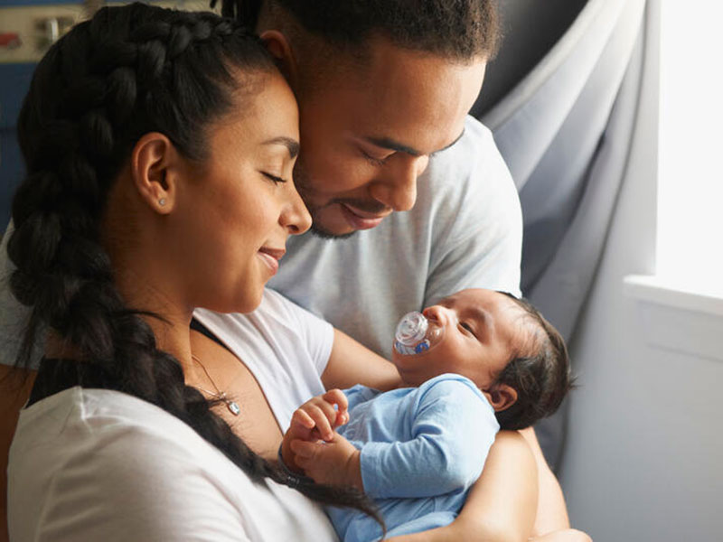portrays a family that is happy cause their baby got protected by insurance plan